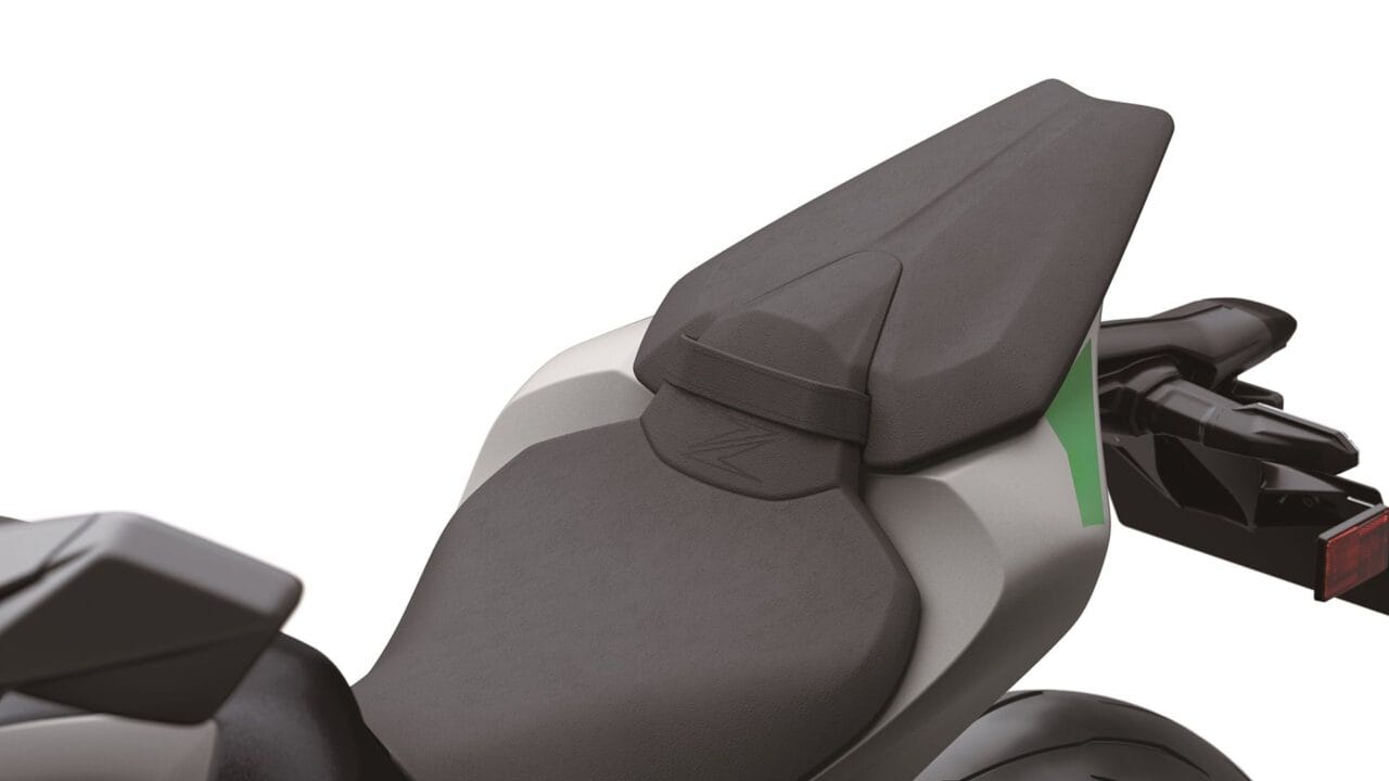Close-up of a motorcycle seat and rear body, showing the textured gray seat and passenger area.