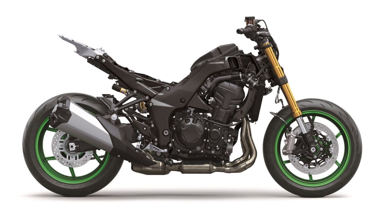 Black sport motorcycle with exposed frame, gold upside-down front forks, and green rims photographed from the side.