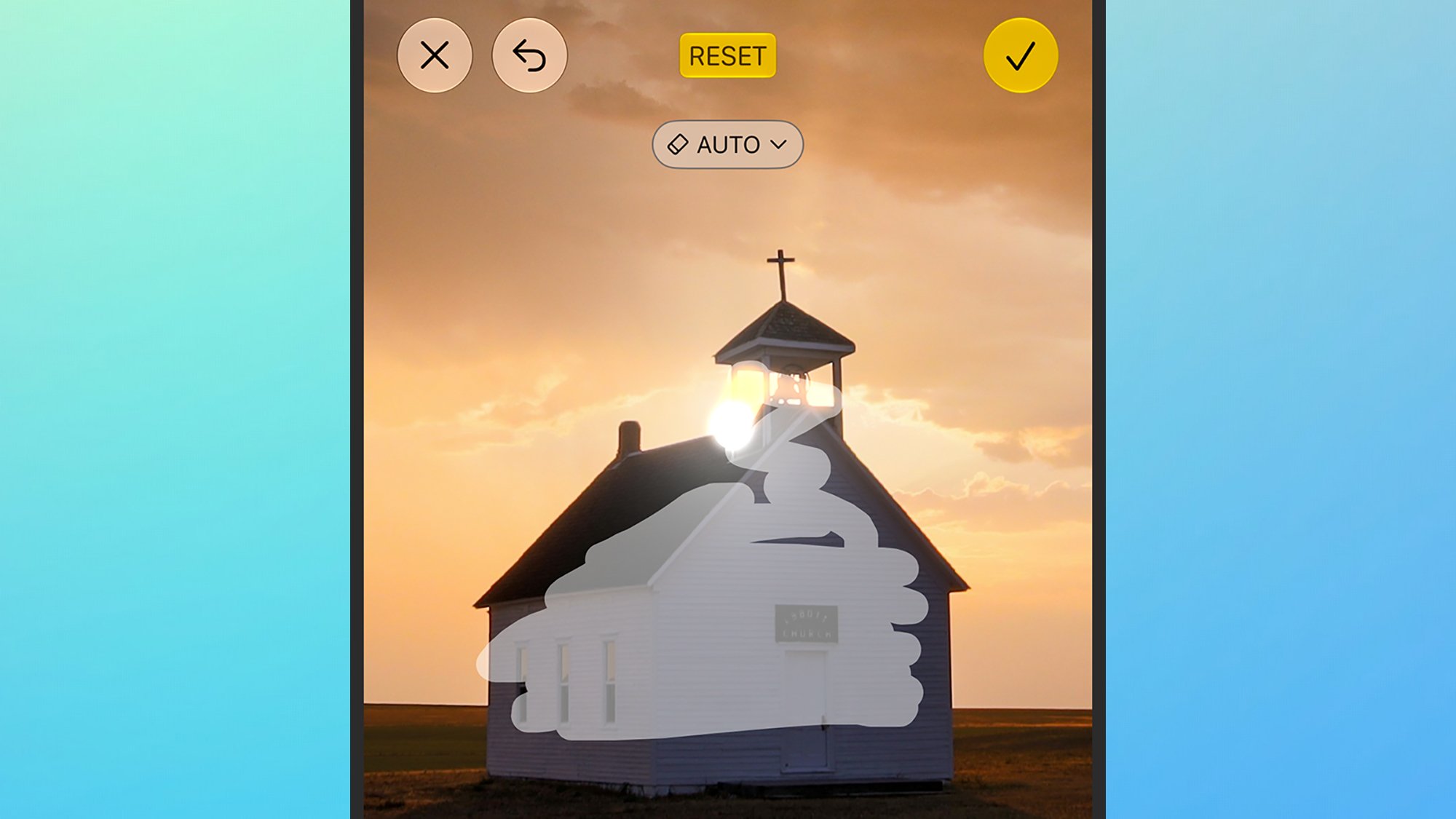 Church building with a cross on the steeple at sunset, partially obscured by a large white cloud-shaped overlay.