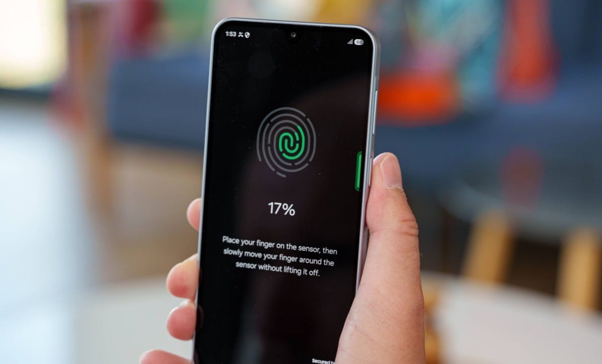 Hand holding a smartphone displaying a fingerprint enrollment screen at 17% progress.