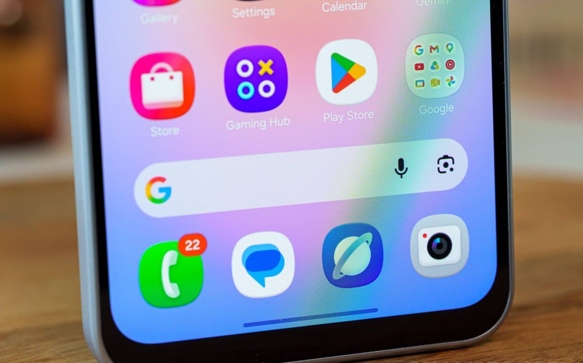 Close-up of a smartphone home screen with colorful app icons and a Google search bar.