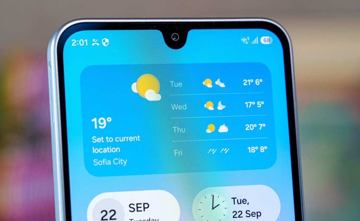 Close-up of a smartphone screen showing a weather widget with 4-day forecast and location Sofia City.