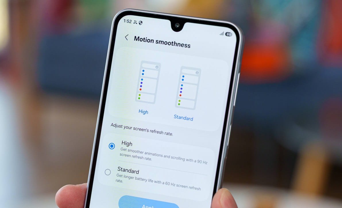Smartphone displaying a settings screen titled 'Motion smoothness' with two diagrams for High and Standard refresh rates and radio buttons below, explaining screen refresh rate options.