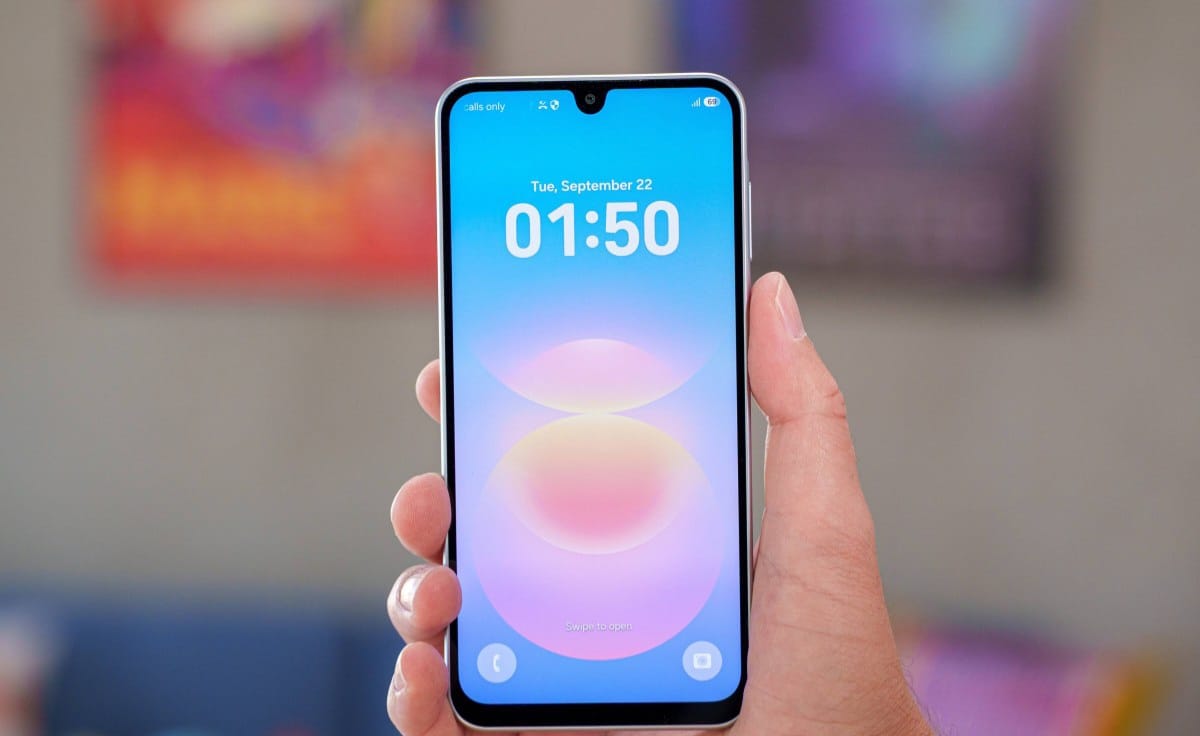 Hand holding a smartphone upright with a blue gradient wallpaper and the time 01:50 on the screen (lock screen).