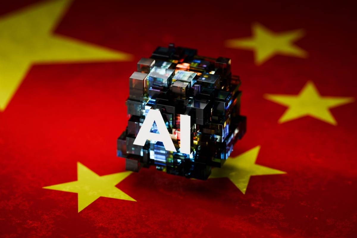 Artificial intelligence concept: a glassy cube with 'AI' on it, set against a Chinese flag background with yellow stars.