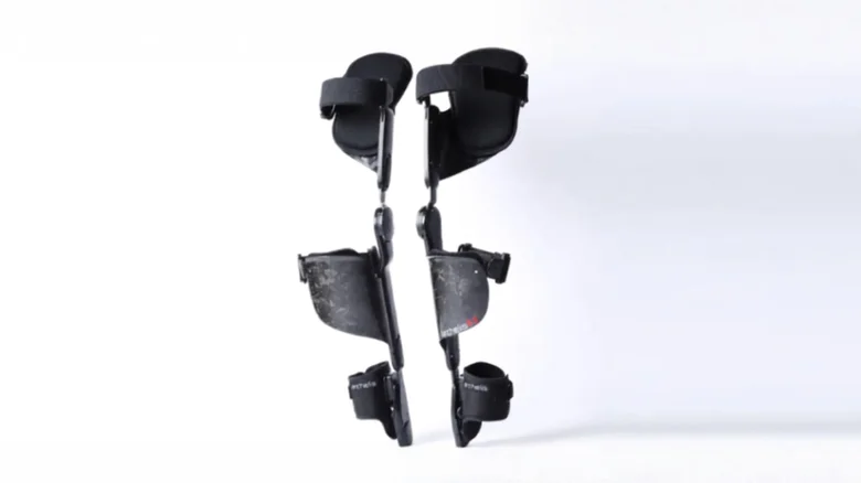Pair of black leg braces with ankle and knee supports, standing against a white background for medical use.