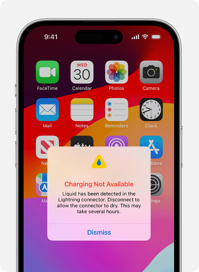 iPhone home screen with app icons and a centered alert: 'Charging Not Available' due to liquid in the Lightning connector; Dismiss button nearby.