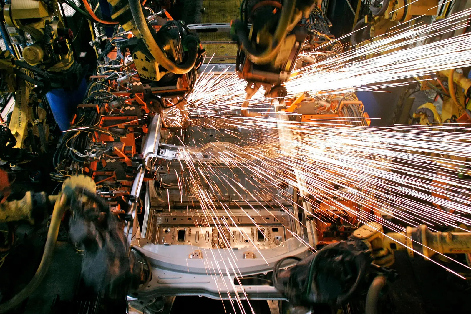 ربات‌های صنعتی در حال جوشکاری بدنه خودرو در کارخانه جنرال موتورز (General Motors)