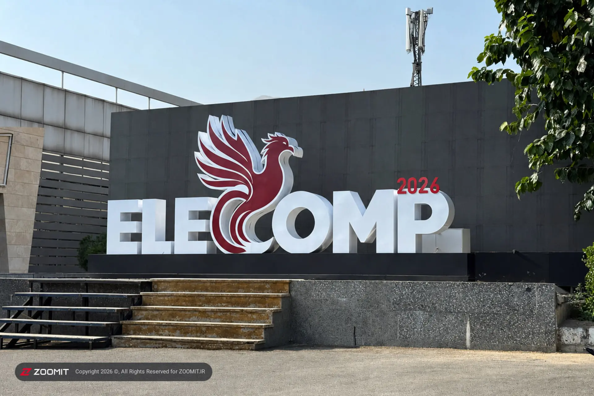 لوگوی نمایشگاه ELECOMP 2026 با نماد ققنوس قرمز و متن سفید